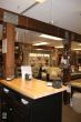 A counter with a cash register protected by a plexiglass suspended by stainless steel cable and a hanging track fixed on the ceiling.