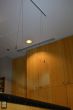 A Plexiglass sheet hangs from a silver Xpo Rail Track installed on the ceiling.
