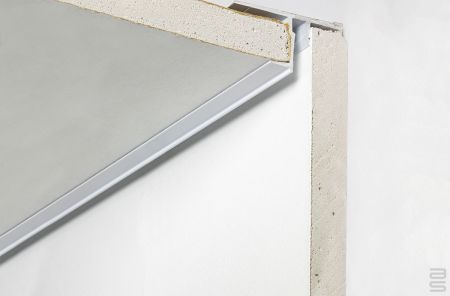 Cross-section detail of shadowline ceiling track system installed between ceiling and wall for discreet picture hanging.