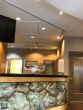 A reception desk in a clinic, protected by a plexiglass suspended by stainless steel cable and a hanging track fixed on the ceiling.