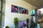 Hanging art on walls with high ceilings