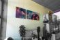 Hanging art on walls with high ceilings