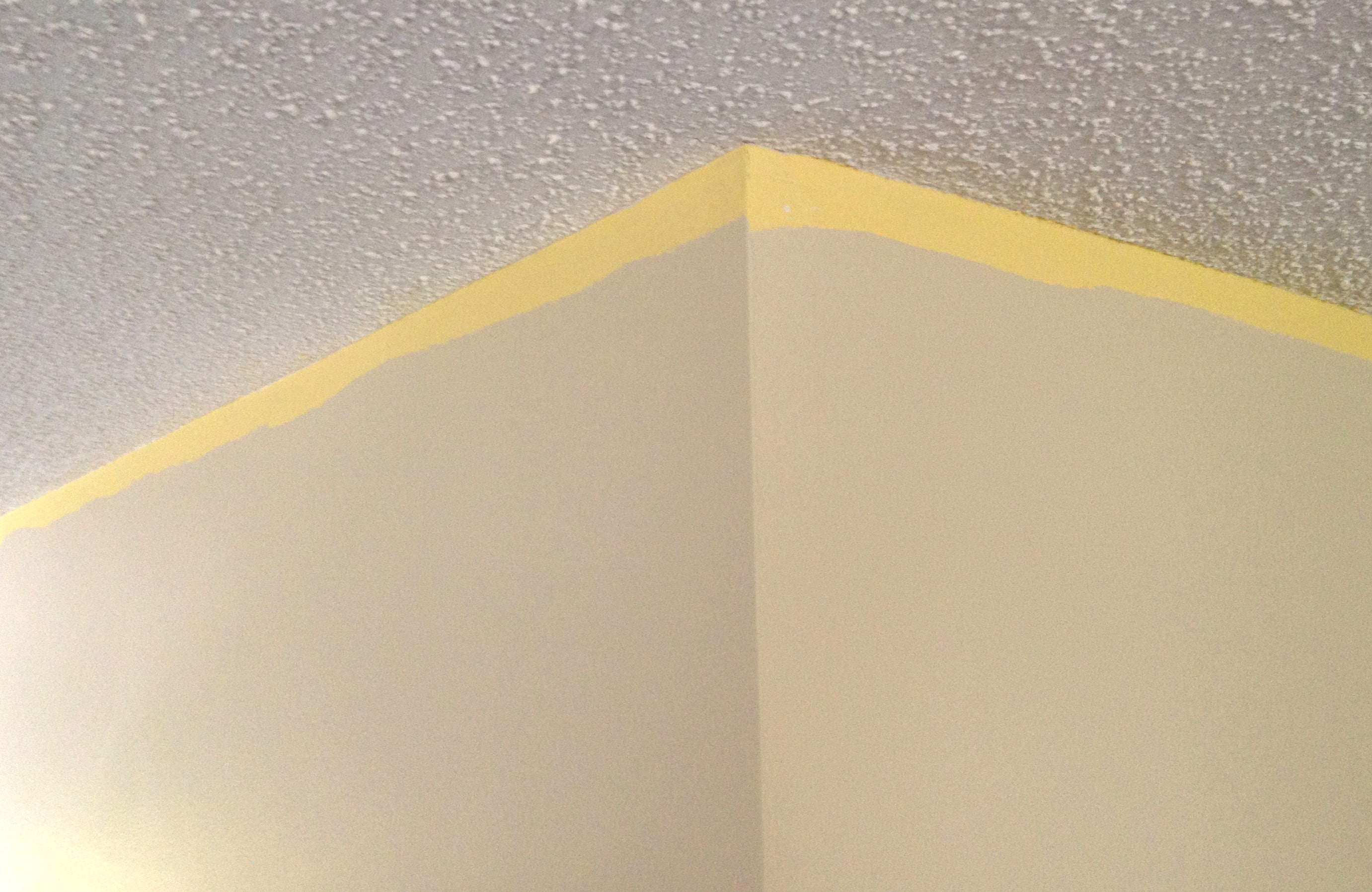 Unpainted top of wall to be covered by crown molding.