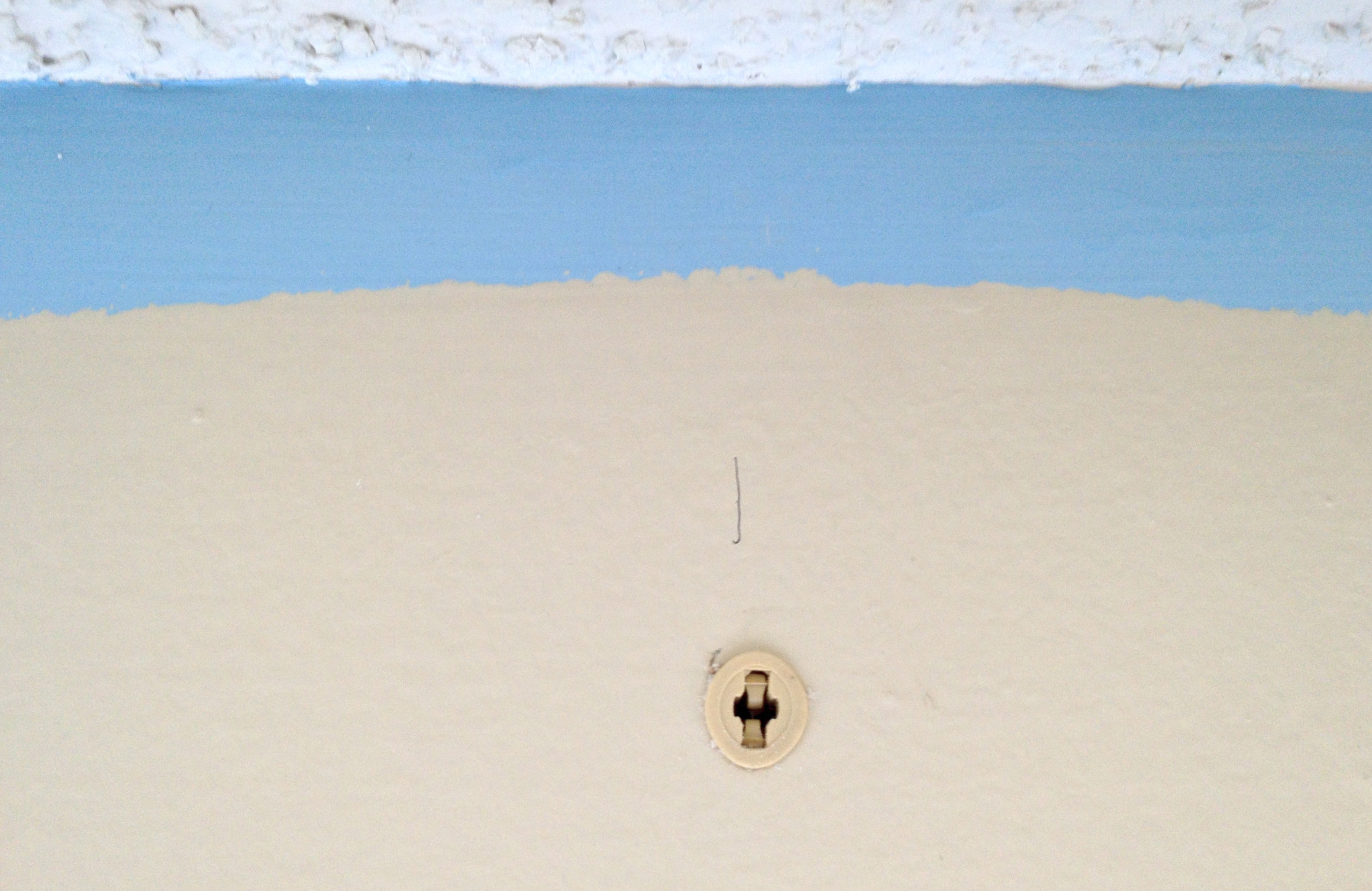 Anchor screws inserted into larger holes.