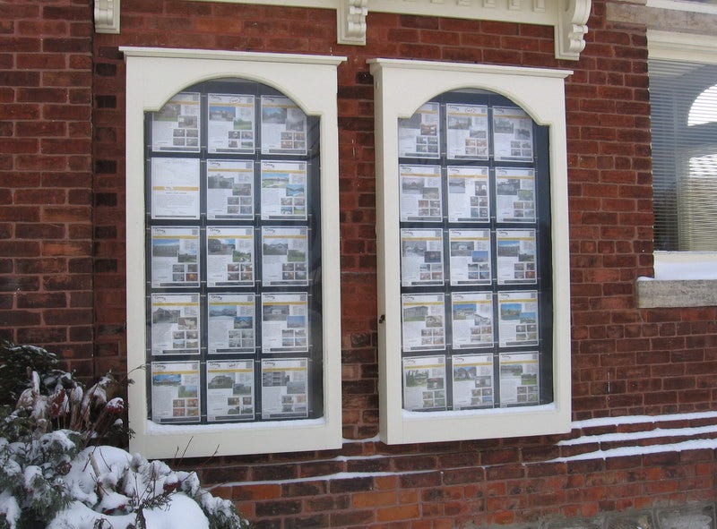 Real Estate Store Window Display Using AS Hanging Systems Pocket Display System