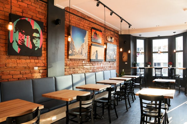 Art wall display on café brick wall using Click Rail System by AS Hanging Systems 