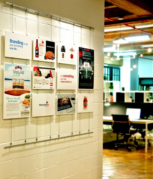 Corporate brag wall using Tensioned Cable System by AS Hanging Systems. 