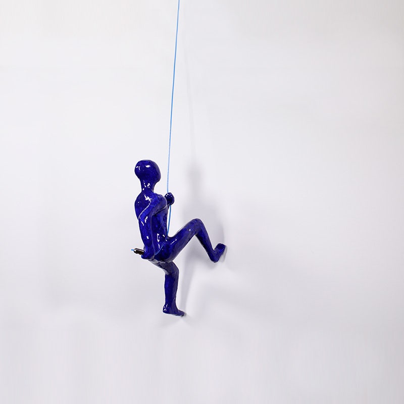 Wall Climber Sculpture suspended in AS Hanging System's Showroom