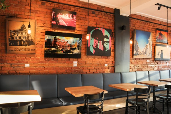 Art wall display on café brick wall using Click Rail System by AS Hanging Systems 