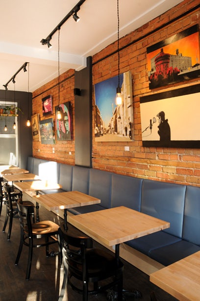 Art wall display on café brick wall using Click Rail System by AS Hanging Systems 