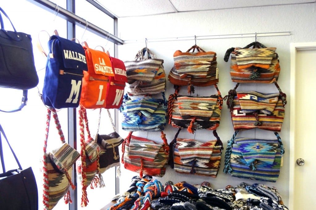 Various-sized Bags are Displayed Using Adjustable Cable System by AS Hanging Systems