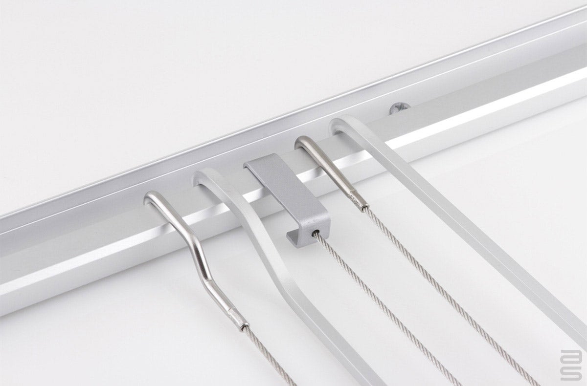 Variety of cables and rods hanging from the Classic Wall Track.